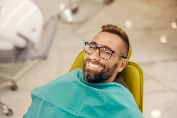 a man on the dental chair smiling widely