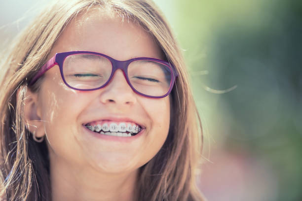 a kid with braces smiling widely