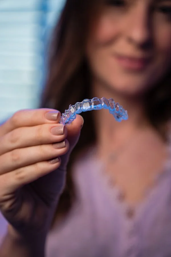 an image of a woman holding an invisalign