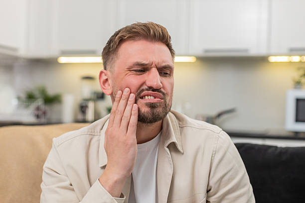 a man grimacing due to toothache