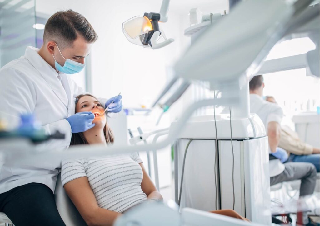 Orthodontist performing a braces evaluation during a dental consultation for teeth alignment and bite correction