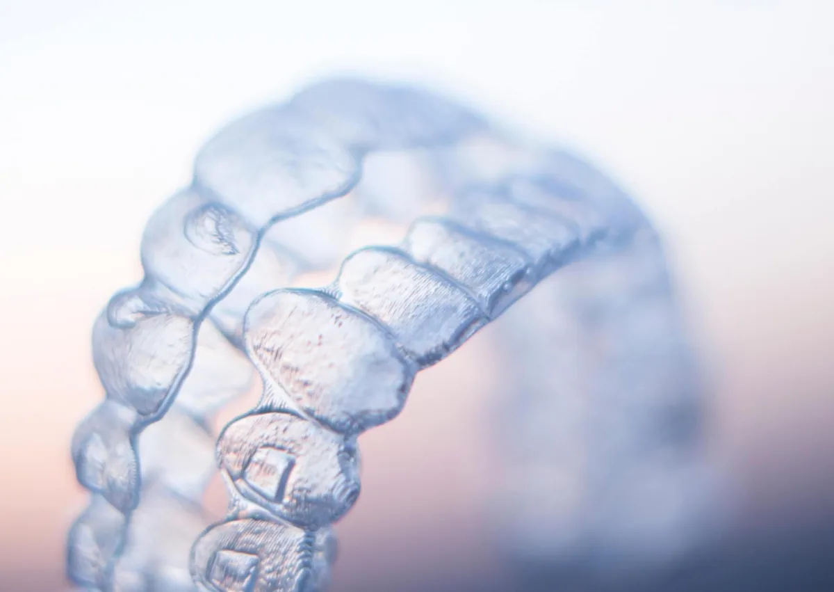 Close-up of a clear dental retainer designed to help maintain tooth alignment after orthodontic treatment.